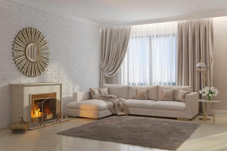 Salotto moderno con nuance di tortora e una parete di finti mattoncini bianchi.